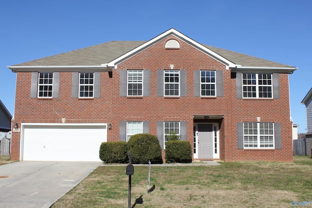 colonial home with a front yard and a garage