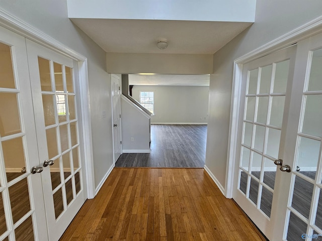 hallway featuring french doors and hardwood / wood-style flooring