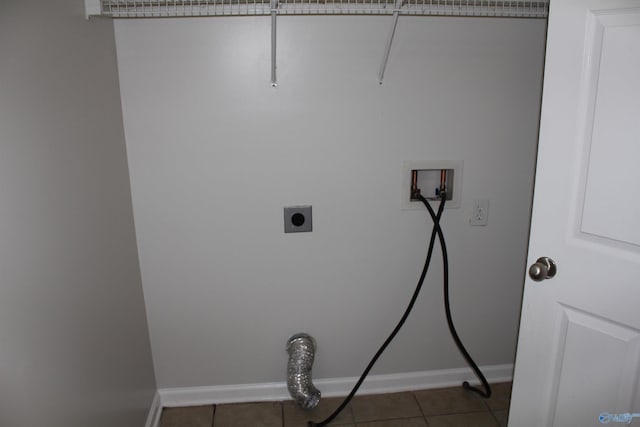 laundry area with washer hookup, hookup for an electric dryer, and dark tile patterned floors