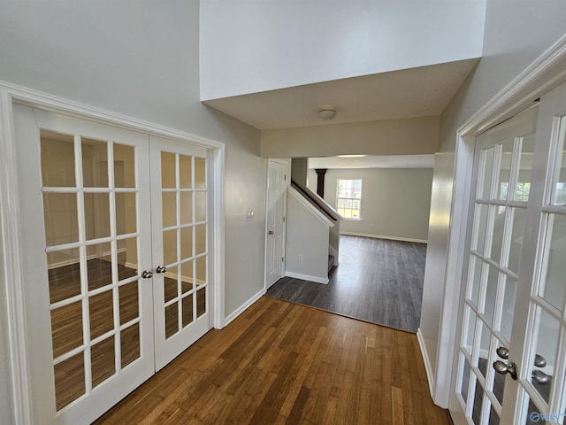 corridor featuring dark wood-type flooring and french doors