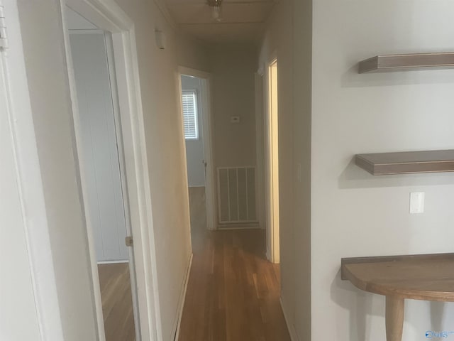 hallway with visible vents and wood finished floors