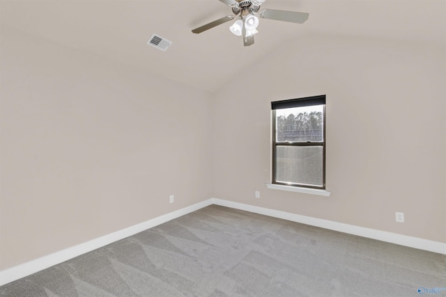 unfurnished room with vaulted ceiling, baseboards, visible vents, and carpet floors