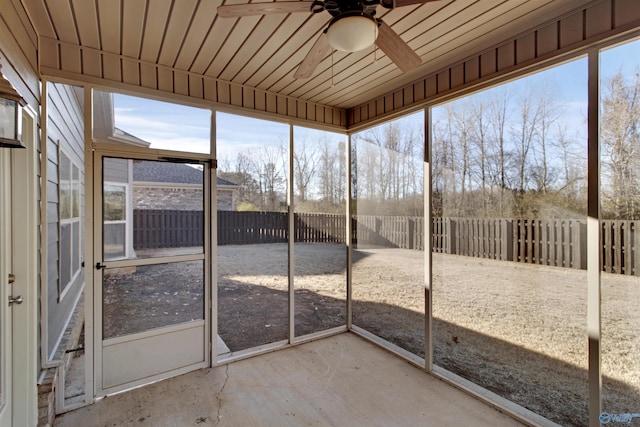 unfurnished sunroom with ceiling fan