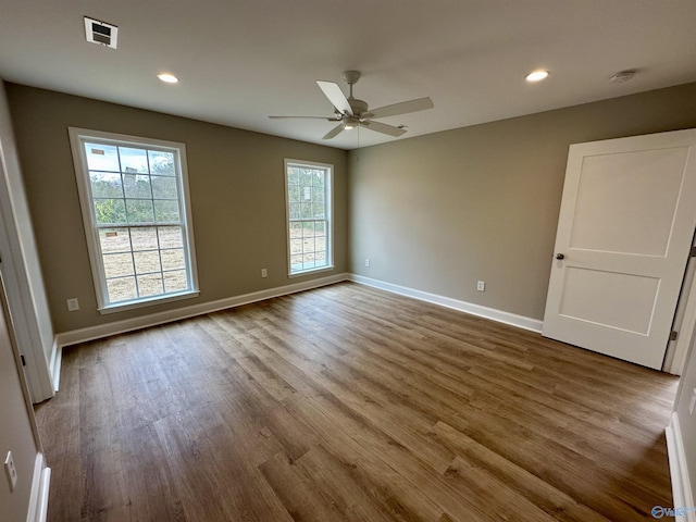 spare room with wood-type flooring and ceiling fan