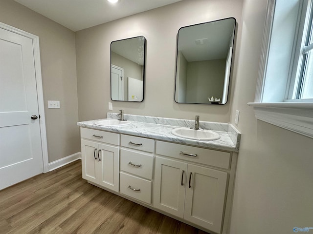 bathroom with hardwood / wood-style floors and vanity