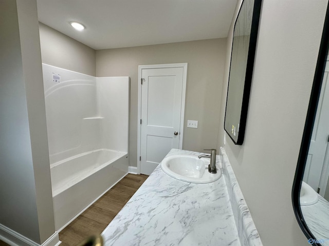 bathroom featuring vanity,  shower combination, and hardwood / wood-style flooring