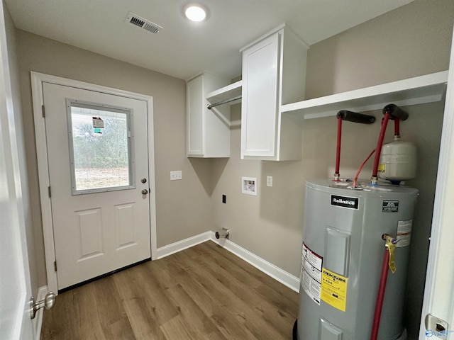 washroom with hookup for an electric dryer, hookup for a washing machine, cabinets, electric water heater, and light hardwood / wood-style flooring