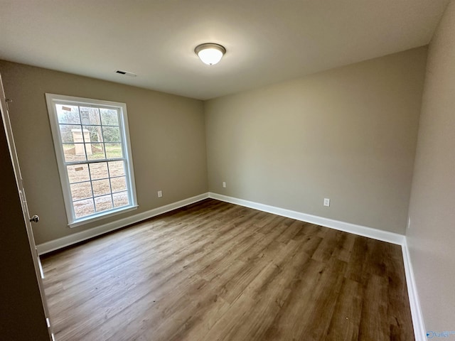 spare room with hardwood / wood-style flooring