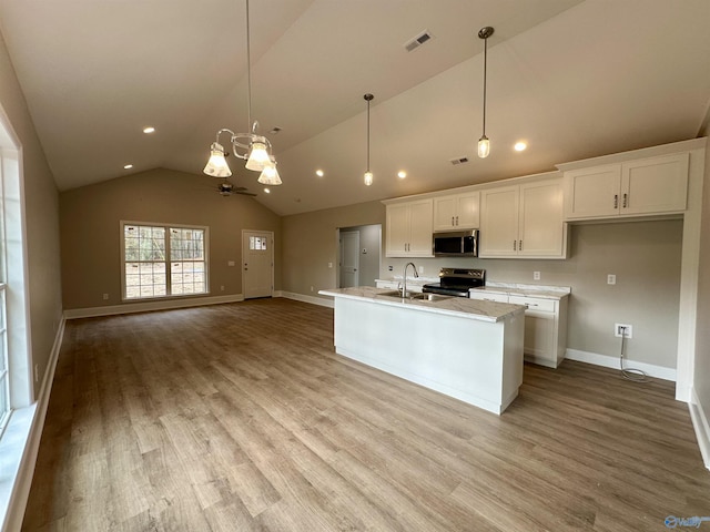 kitchen with white cabinetry, ceiling fan, hanging light fixtures, a center island with sink, and appliances with stainless steel finishes