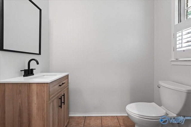 bathroom featuring tile patterned floors, toilet, and vanity