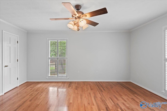 spare room featuring ornamental molding, light wood-type flooring, and ceiling fan