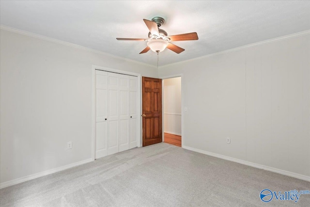 unfurnished bedroom with ornamental molding, light carpet, a closet, and ceiling fan