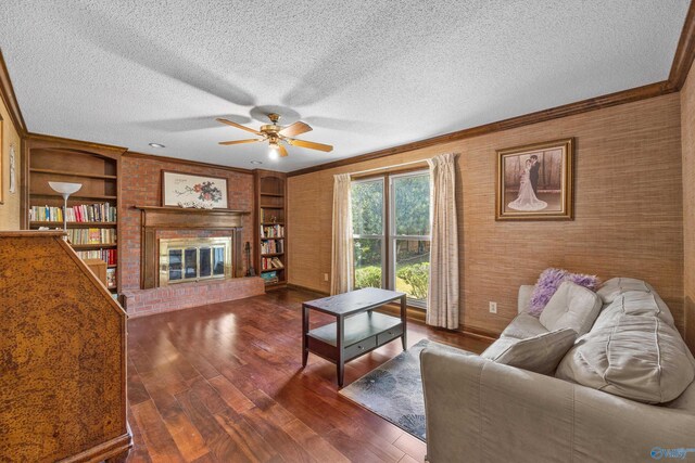 unfurnished living room with a brick fireplace, a textured ceiling, crown molding, and dark wood-type flooring