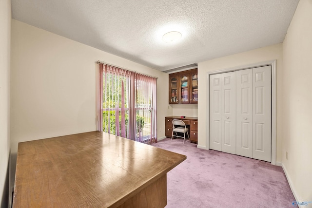 unfurnished office with a textured ceiling and carpet