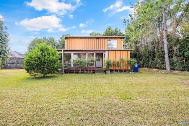 rear view of property with a yard