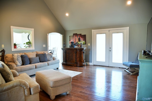 living room featuring dark wood-type flooring, high vaulted ceiling, and french doors