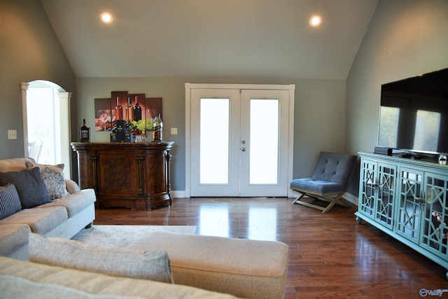 living room featuring dark hardwood / wood-style flooring, lofted ceiling, and french doors