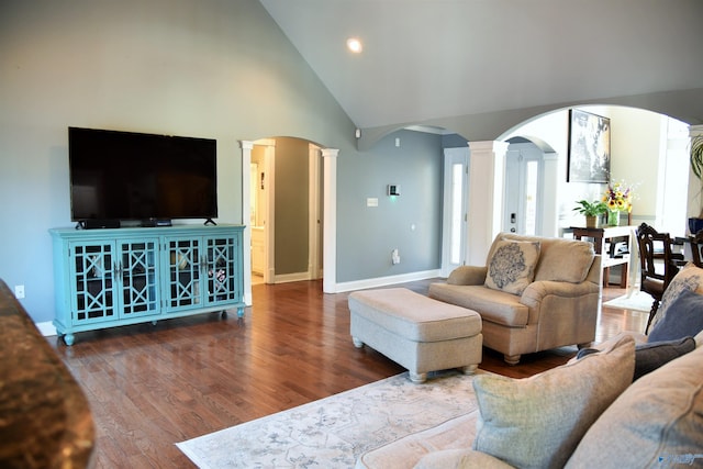 living room featuring decorative columns, dark hardwood / wood-style floors, and high vaulted ceiling