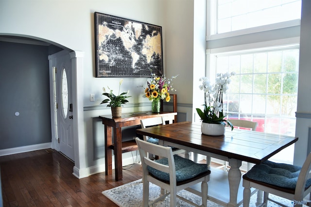 dining space with dark wood-type flooring