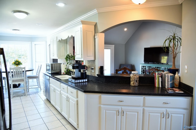 kitchen featuring white cabinetry, stainless steel dishwasher, and ornamental molding