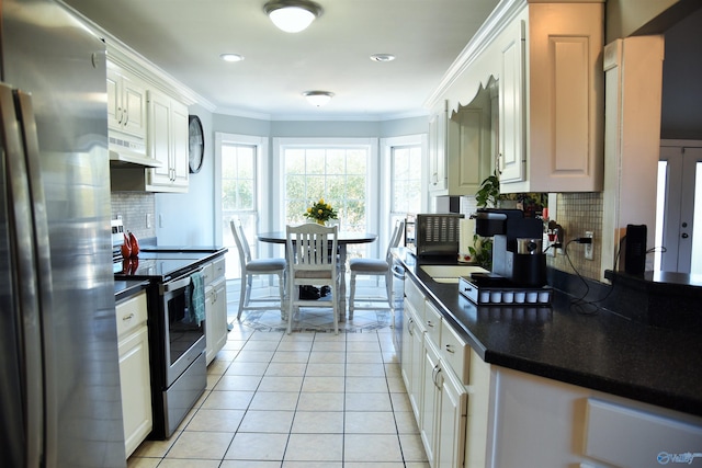 kitchen featuring white cabinets, stainless steel appliances, and tasteful backsplash