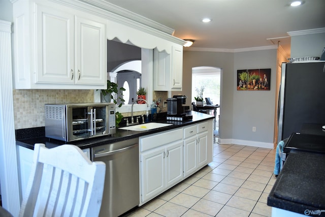 kitchen featuring sink, white cabinetry, appliances with stainless steel finishes, and ornamental molding