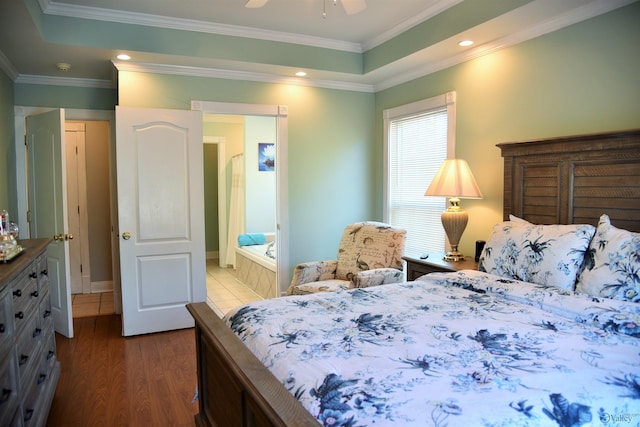 bedroom featuring hardwood / wood-style flooring, ensuite bath, ceiling fan, and ornamental molding