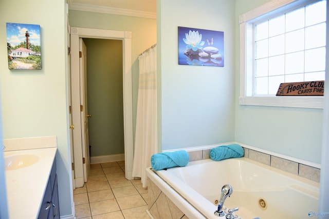 bathroom with tile patterned flooring, tiled tub, vanity, and a healthy amount of sunlight