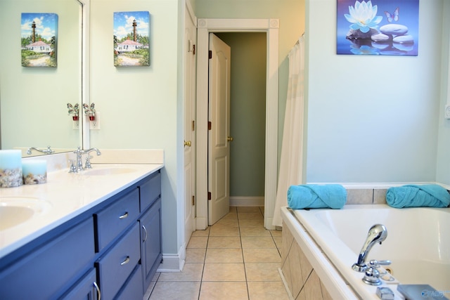 bathroom with tiled tub, tile patterned floors, and vanity