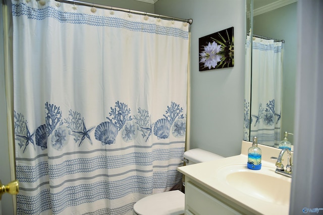 bathroom featuring ornamental molding, toilet, and vanity