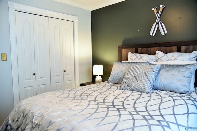 bedroom with a closet and crown molding