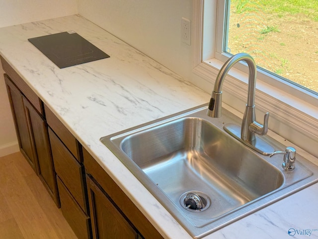 140 Ben Johnson Rd, Pulaski, TN 38478 - kitchen view of a sink, light stone counters, and black electric stovetop