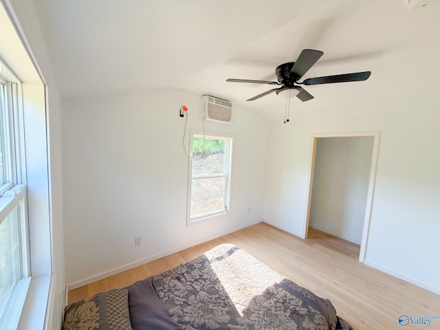 140 Ben Johnson Rd, Pulaski, TN 38478 - bedroom with a wall mounted AC, light wood-style flooring, ceiling fan, baseboards, and vaulted ceiling