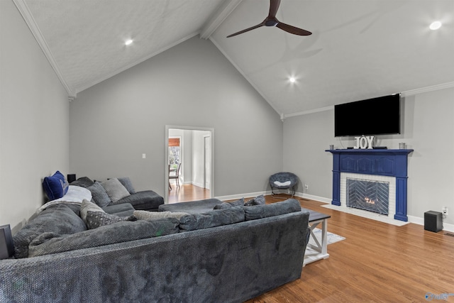 living room with a fireplace with flush hearth, baseboards, wood finished floors, and beamed ceiling