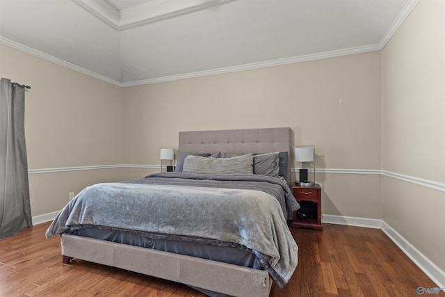 bedroom featuring crown molding, baseboards, and wood finished floors