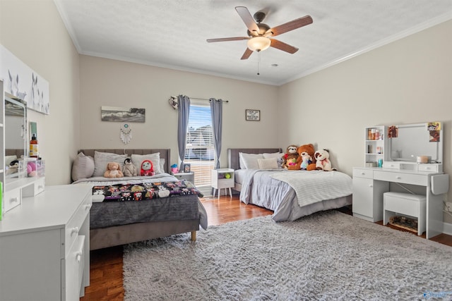 bedroom with ceiling fan, crown molding, and wood finished floors