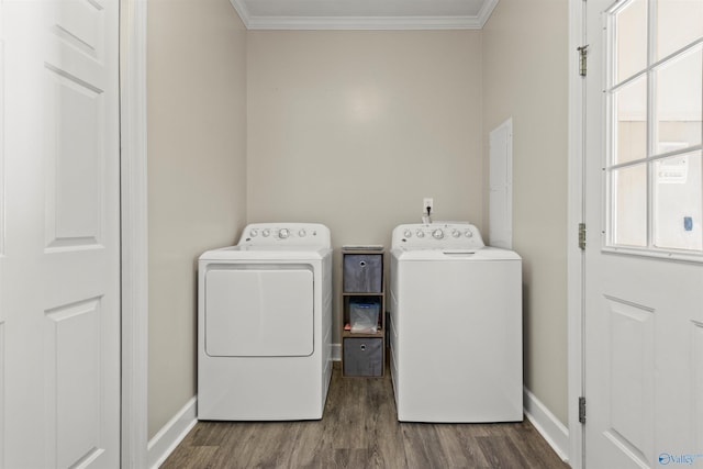 washroom with ornamental molding, laundry area, a healthy amount of sunlight, and washing machine and clothes dryer