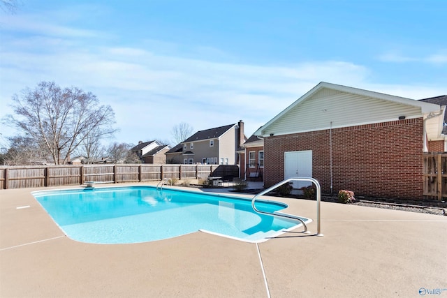 view of swimming pool featuring a patio, a fenced backyard, and a fenced in pool