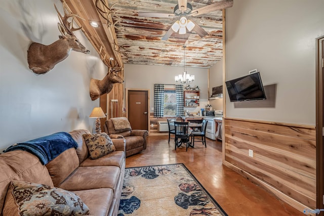 living room featuring a chandelier, wainscoting, and a high ceiling