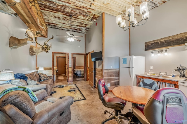 living room with high vaulted ceiling, wood ceiling, concrete flooring, and ceiling fan with notable chandelier