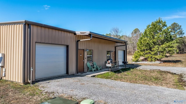 view of front of home with driveway and a detached garage