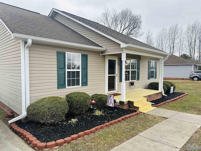 view of exterior entry featuring a yard