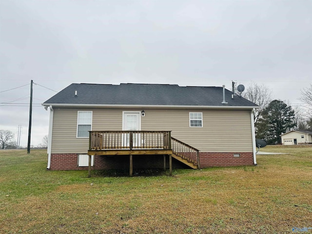 rear view of house featuring a lawn and a wooden deck