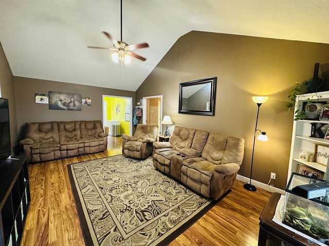 living room featuring hardwood / wood-style floors, vaulted ceiling, and ceiling fan