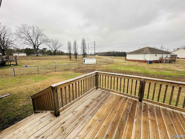 wooden terrace featuring a yard and a rural view