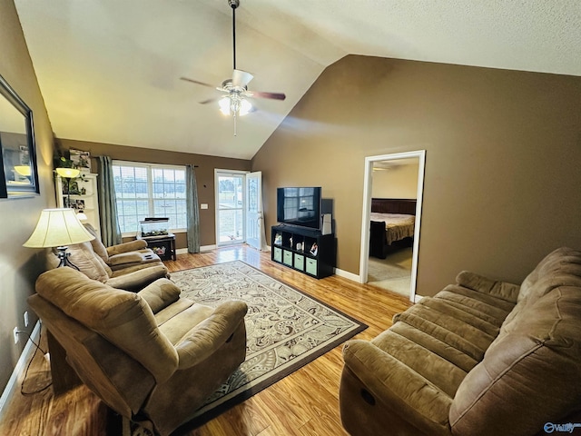 living room featuring light wood-type flooring, ceiling fan, and lofted ceiling