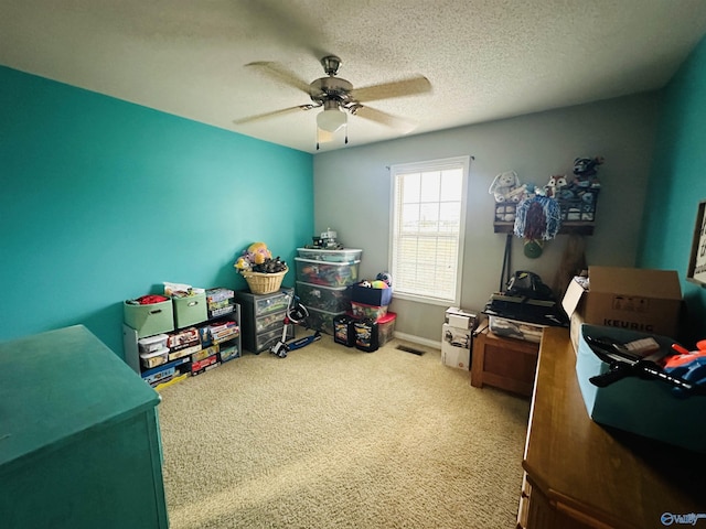 interior space with carpet flooring, a textured ceiling, and ceiling fan