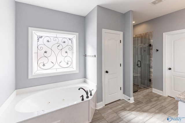 bathroom featuring separate shower and tub