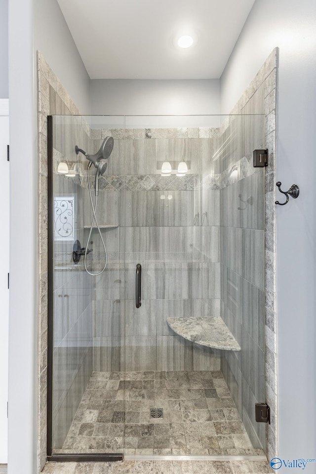 bathroom with a shower with shower door