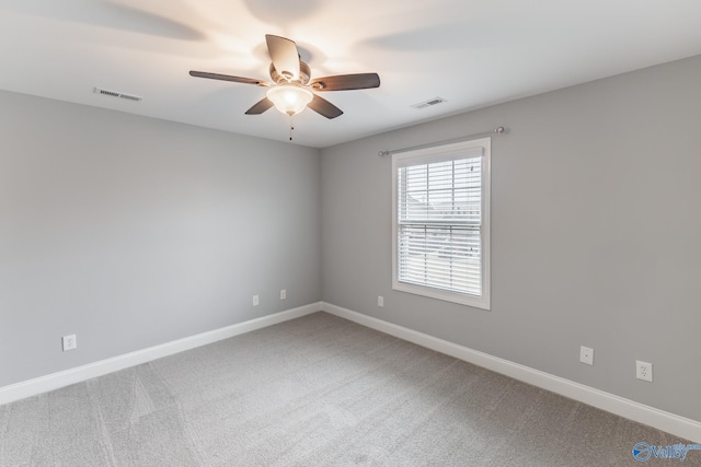 carpeted spare room with ceiling fan